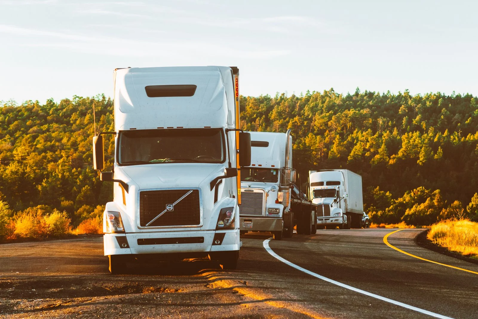 Freight trucks on an open road, illustrative stock photograph